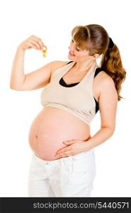 Smiling pregnant woman holding baby dummy near tummy isolated on white&#xA;