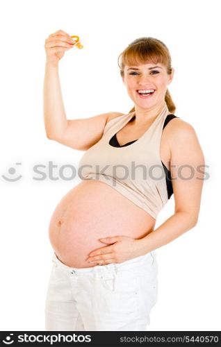 Smiling pregnant woman holding baby dummy &#xA;