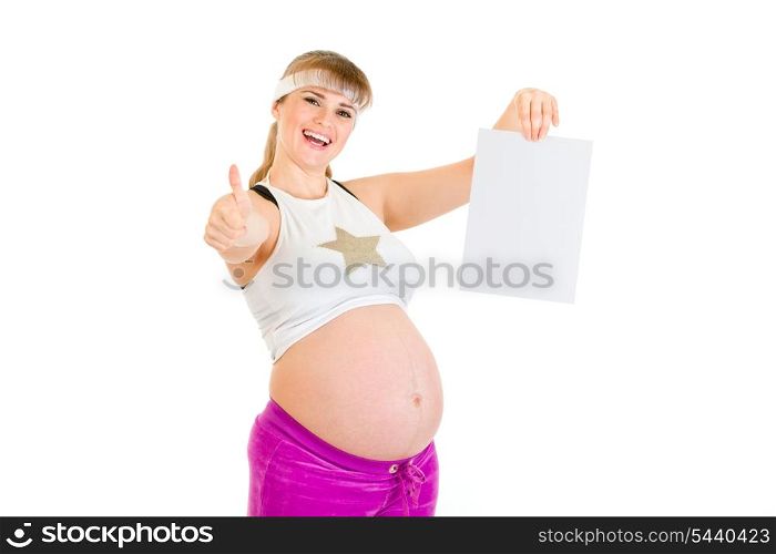 Smiling pregnant woman holding empty white paper and showing thumbs up gesture isolated on white&#xA;