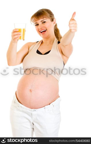 Smiling pregnant woman holding glass of juice and showing thumbs up gesture isolated on white&#xA;