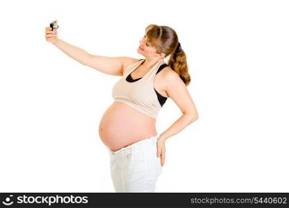 Smiling pregnant woman photographing herself isolated on white&#xA;