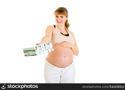 Smiling pregnant woman touching her belly and holding present for baby isolated on white&#xA;