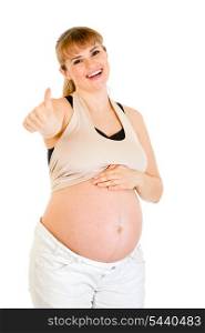 Smiling pregnant woman touching her belly and showing thumbs up gesture isolated on white&#xA;