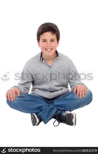 Smiling preteen boy sitting on the floor isolated on a white background