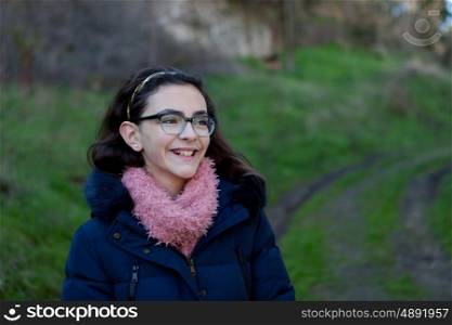 Smiling preteen girl in the field at winter