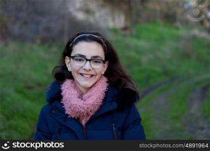 Smiling preteen girl in the field at winter