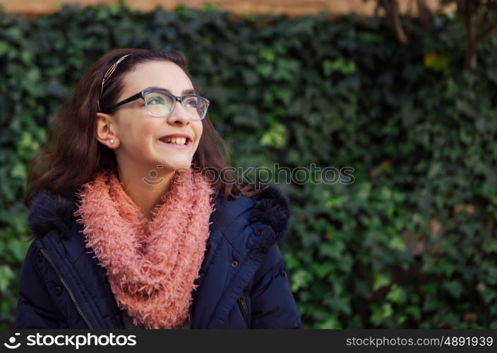 Smiling preteen girl in the garden at winter