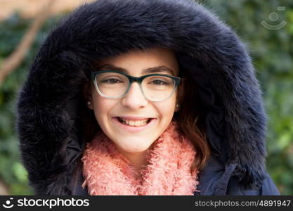 Smiling preteen girl in the garden at winter