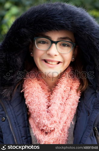 Smiling preteen girl in the garden at winter