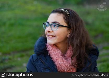 Smiling preteen girl in the garden at winter