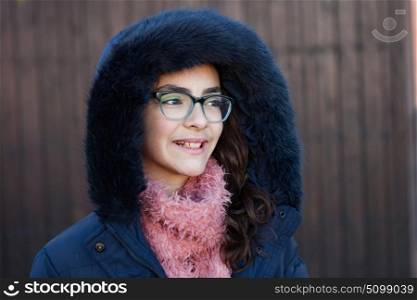 Smiling preteen girl wearing fur hood at winter
