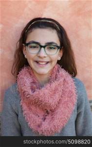 Smiling preteen girl wearing pink scarf and glasses