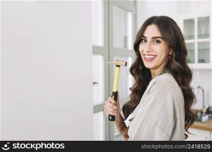smiling pretty woman with hammer