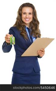 Smiling realtor woman giving with clipboard keys