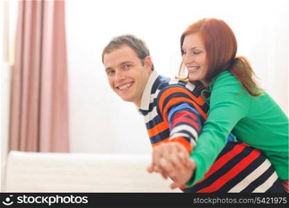 Smiling red hair young woman piggybacking boyfriend