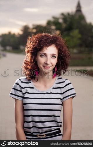 Smiling redhead women outdoors backlit weared stripped dress