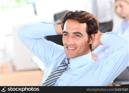Smiling relaxed businessman in office