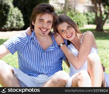 Smiling romantic young couple at park