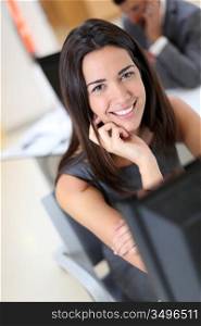 Smiling secretary sitting at her desk