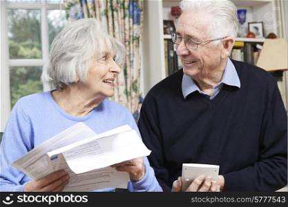 Smiling Senior Couple Reviewing Home Finances