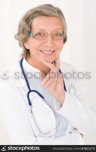 Smiling senior doctor female with stethoscope professional portrait