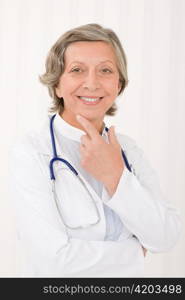 Smiling senior doctor female with stethoscope professional portrait