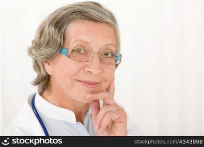 Smiling senior doctor female with stethoscope professional portrait
