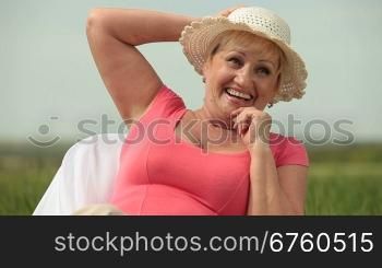Smiling senior lady enjoying retirement on the nature