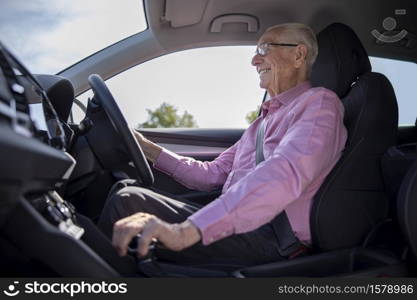 Smiling Senior Man Enjoying Driving Car