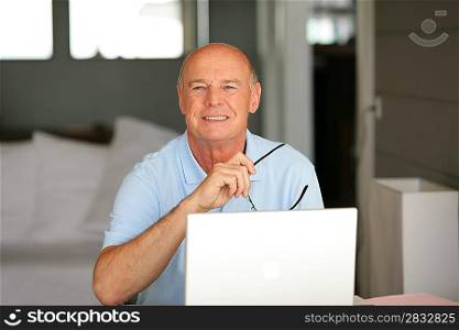 Smiling senior with a laptop