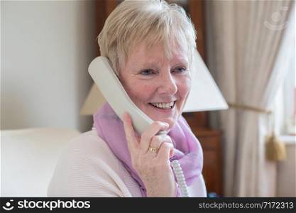 Smiling Senior Woman Making Phone Call At Home