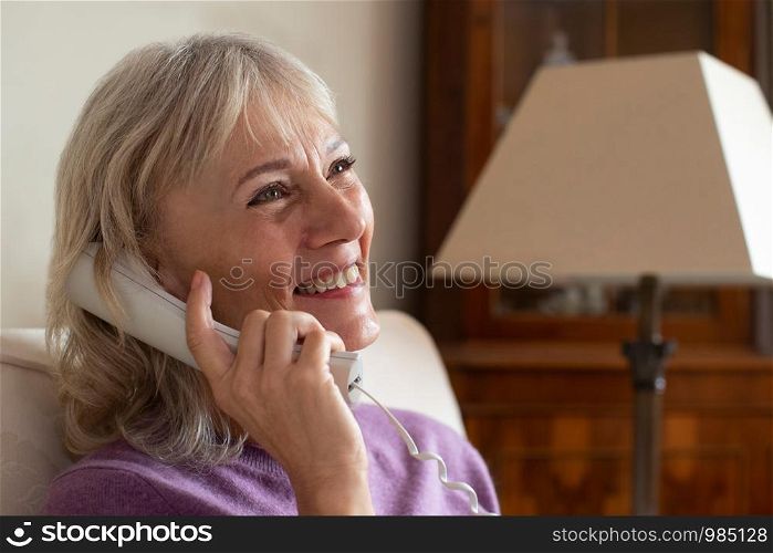 Smiling Senior Woman Using Phone At Home