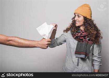 smiling sick woman taking tissue paper from man s hand
