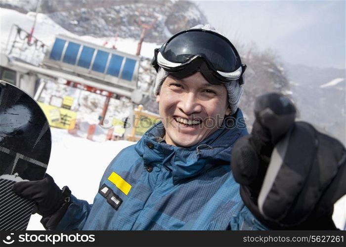 Smiling Snowboarder in Ski Resort