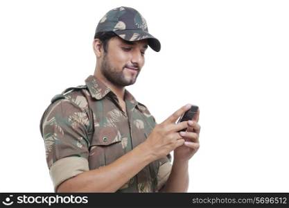 Smiling soldier texting on cell phone