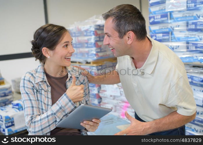 smiling staff managing the stocks at supermarket