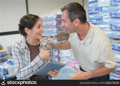 smiling staff managing the stocks at supermarket