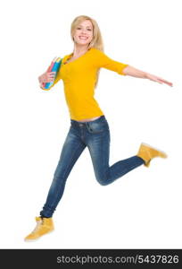 Smiling student girl with books jumping