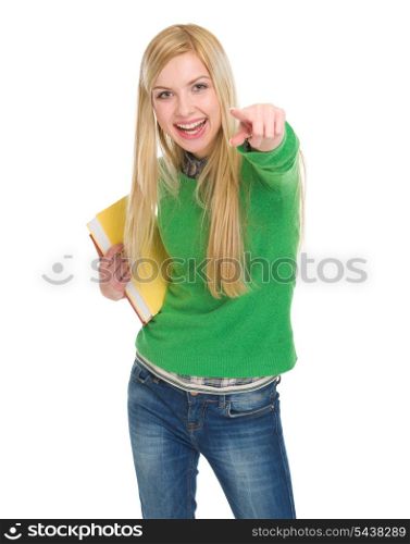 Smiling student girl with books pointing in camera