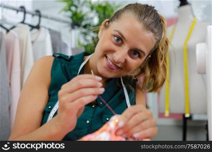 smiling tailor at her workshop