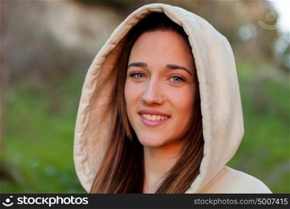 Smiling teen girl outside with a natural green of background