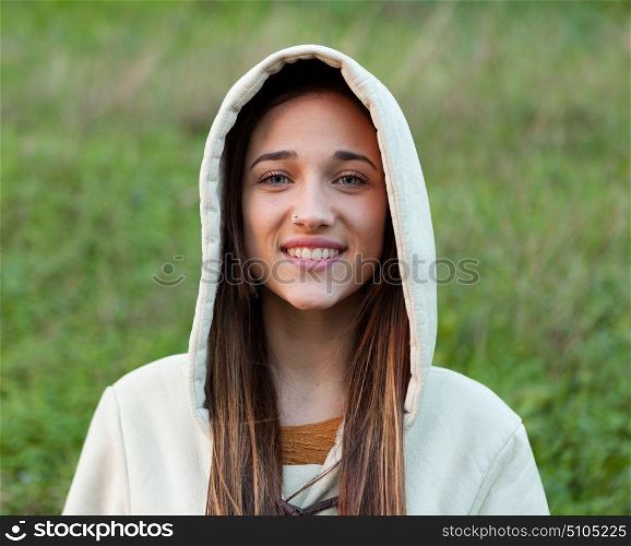 Smiling teen girl outside with a natural green of background