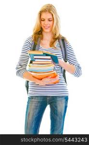 Smiling teen girl with pile of schoolbooks in hands reading isolated on white &#xA;