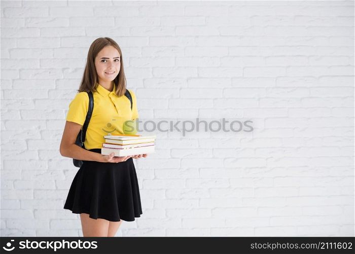 smiling teen girl with textbooks