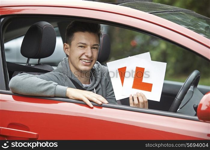 Smiling Teenage Boy In Car Passing Driving Exam