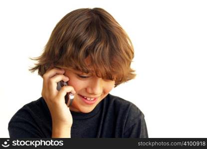 Smiling teenage boy talking on mobile phone isolated on white background.