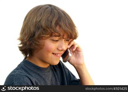 Smiling teenage boy talking on mobile phone isolated on white background.