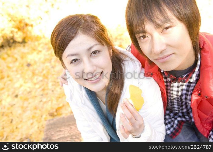 Smiling teenage couple in the woods