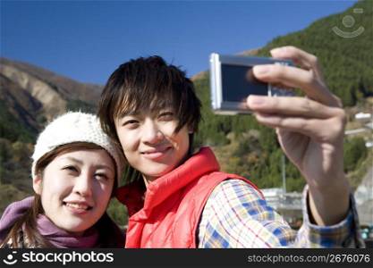 Smiling teenage couple posing for a photo