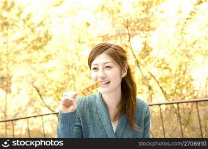 Smiling teenage girl eating